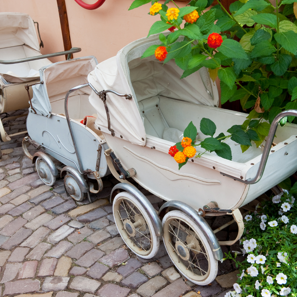 old style pram with flowers outside
